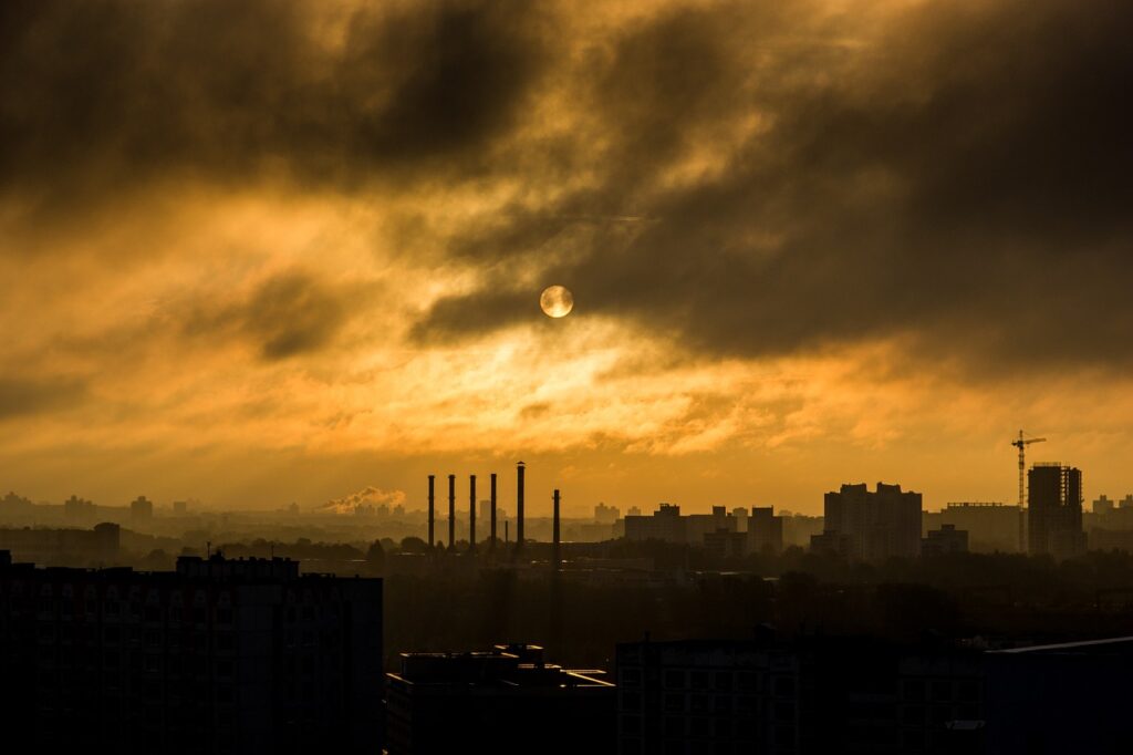 A view of the sun setting over a city.