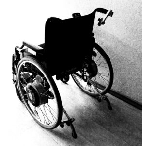 A wheelchair is shown in black and white.