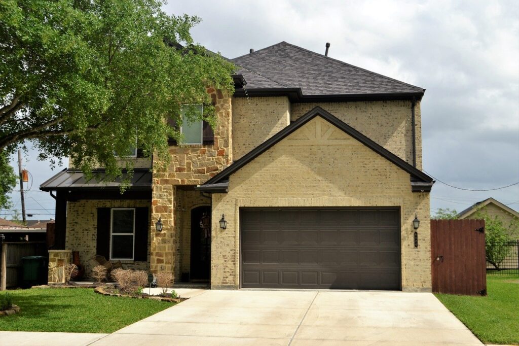 A large house with a garage in the front yard.