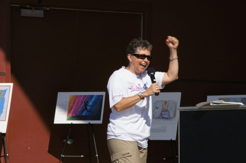 A man in white shirt holding up his fist.