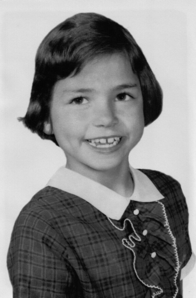 A young girl is smiling for the camera.