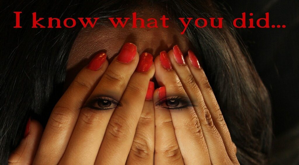 A woman with red nails covering her face.