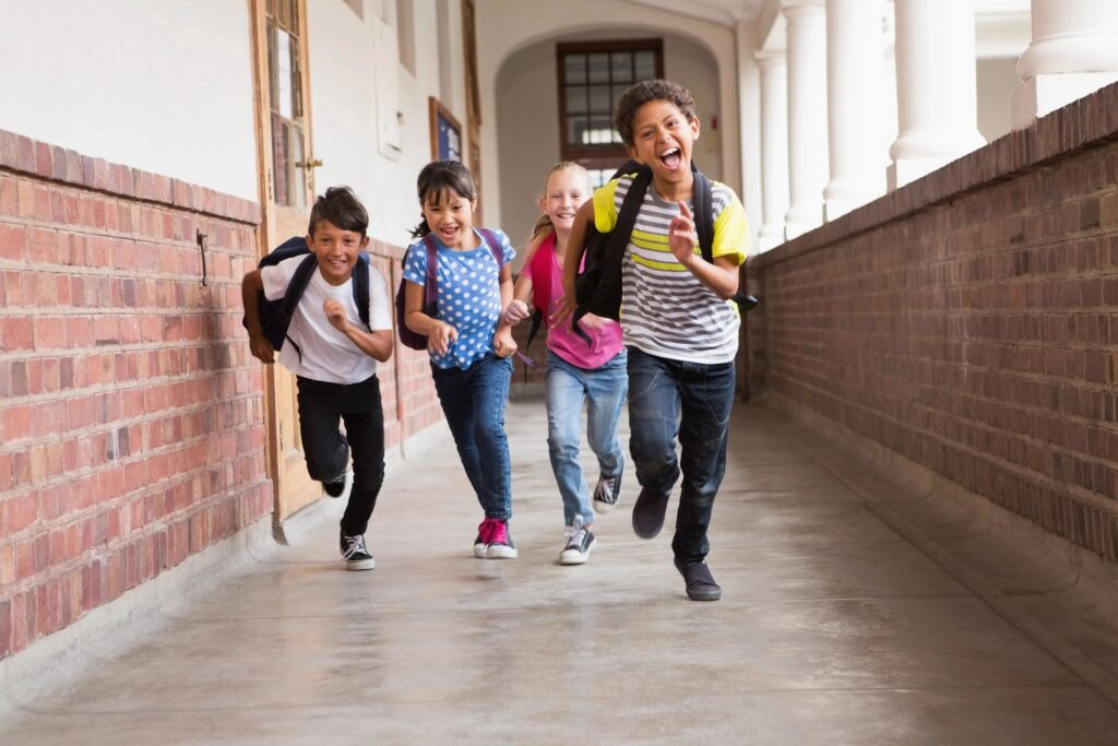 A group of children running down the hallway